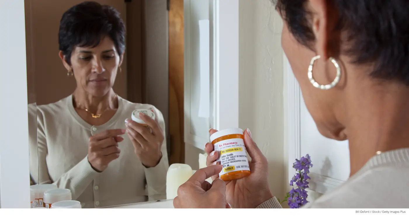 Mature woman taking prescription.