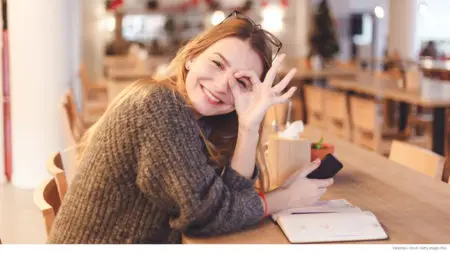Woman making free hand sign